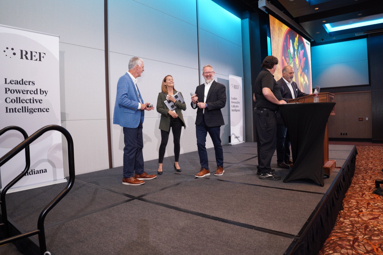 Angie Carel moderating a panel on stage