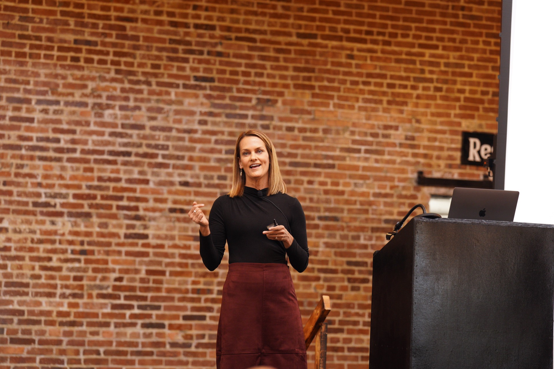 Angie Carel speaking on stage